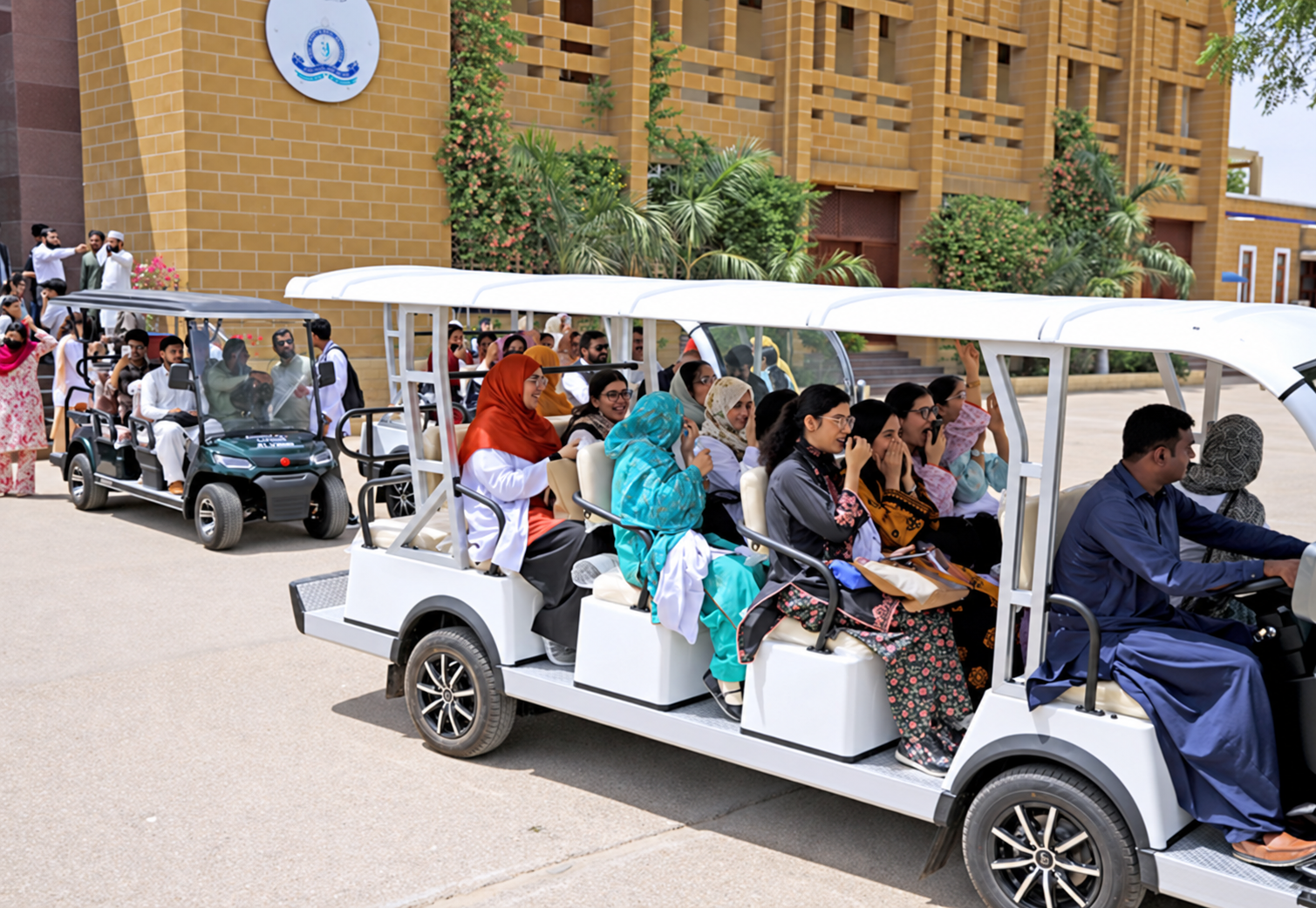 AI-enhanced version of the supplied photograph showing the large white electric shuttle carrying women on the LUMHS campus.